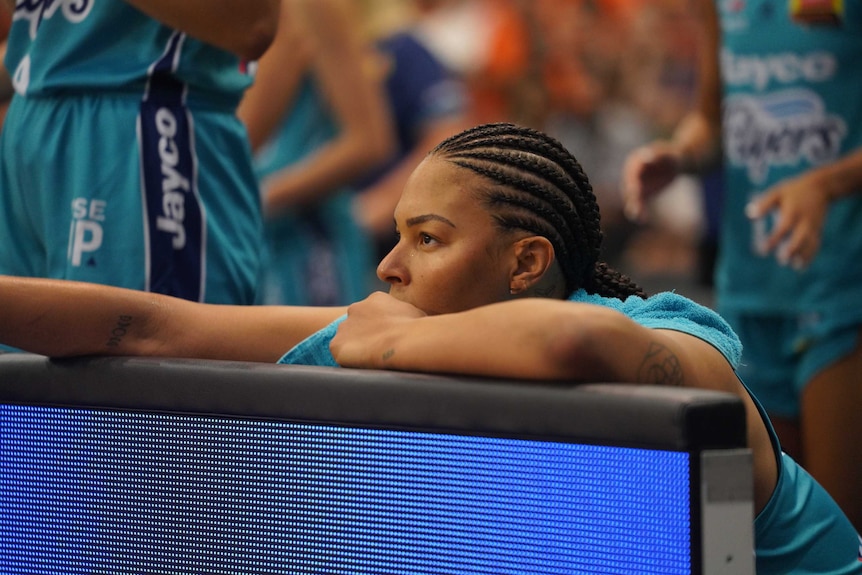 Liz Cambage sits on the bench during the WNBL grand final between Southside Flyers and Townsville Fire.