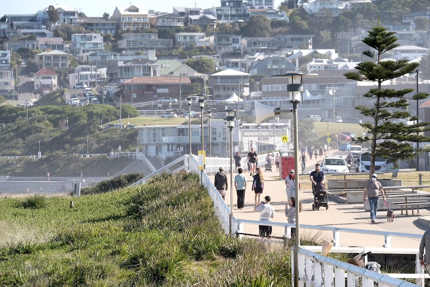 People walking along a beach.