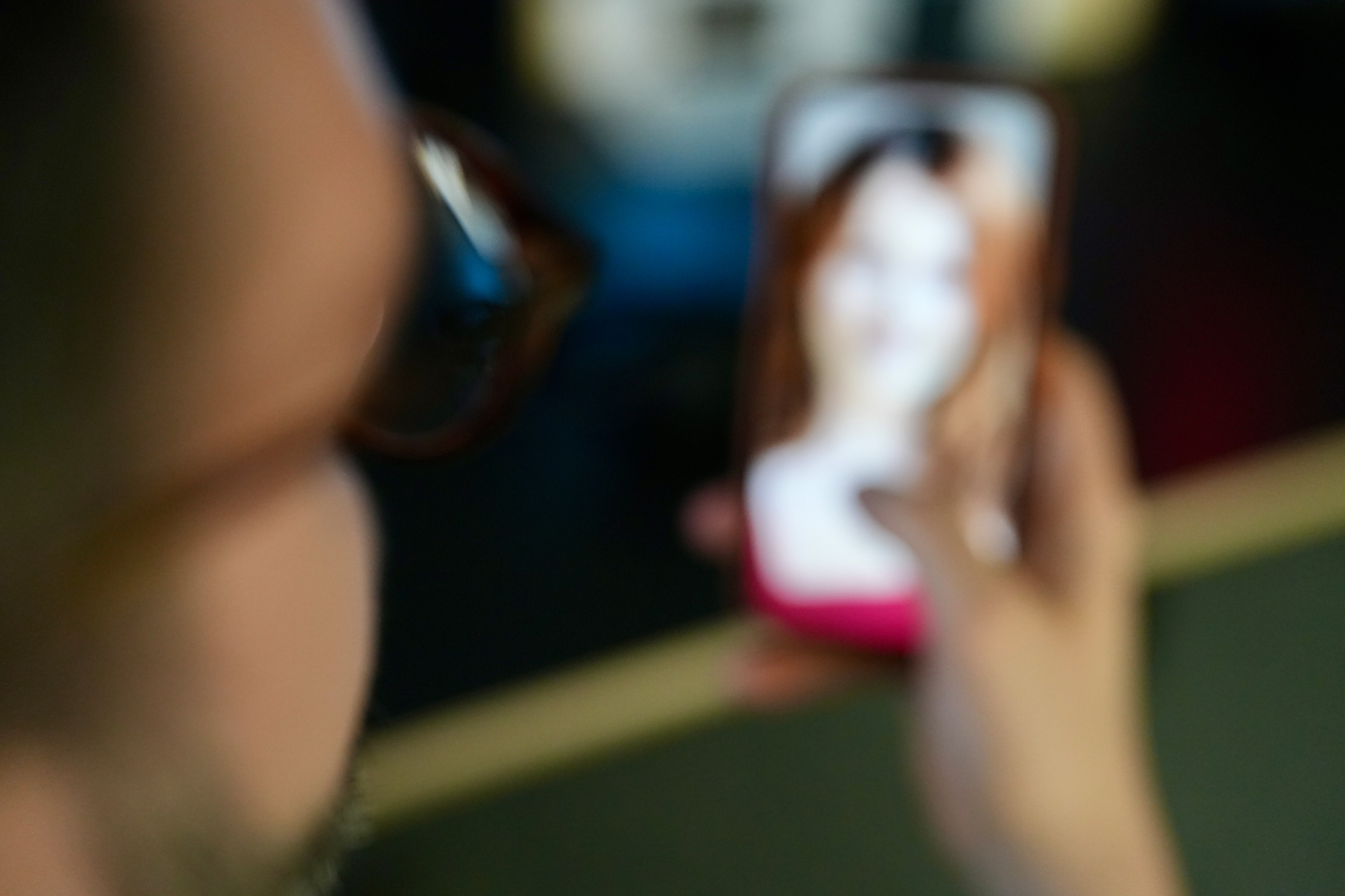 Man holding a mobile phone looking at a woman generic