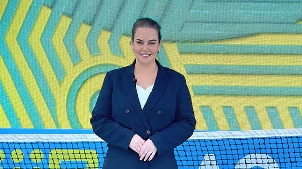 Jelena Dokic wears a suit and smiles at the camera at the tennis.