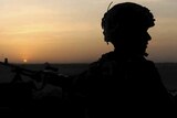 Silhouetted British soldier in Afghanistan, head turned to side - good generic