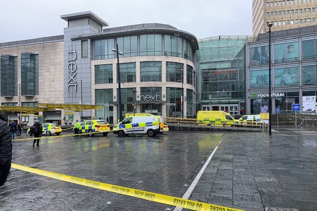 A mall in Manchester with police tape in front.