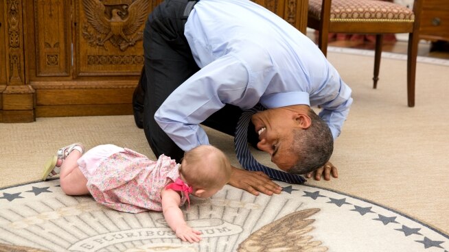 President Barack Obama plays with Ella Harper Rhodes.