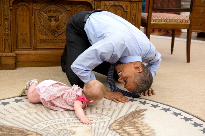 President Barack Obama plays with Ella Harper Rhodes.