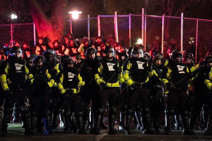 Authorities advance on demonstrators gathered outside the Brooklyn Centre Police Department.