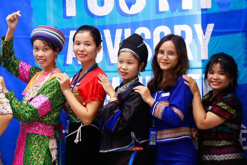 Mai, far left, wearing a traditional outfit, with other other Vietnamese ladies behind her.