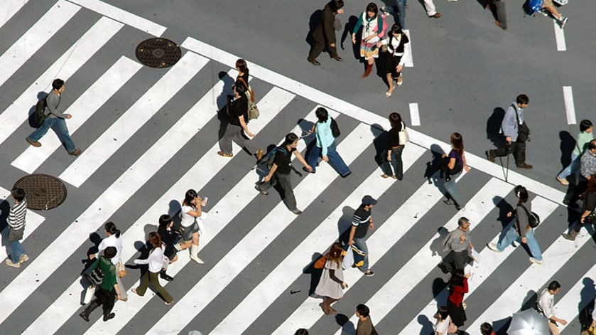 People walk over a pedestrian crossing in Tokyo, Japan.