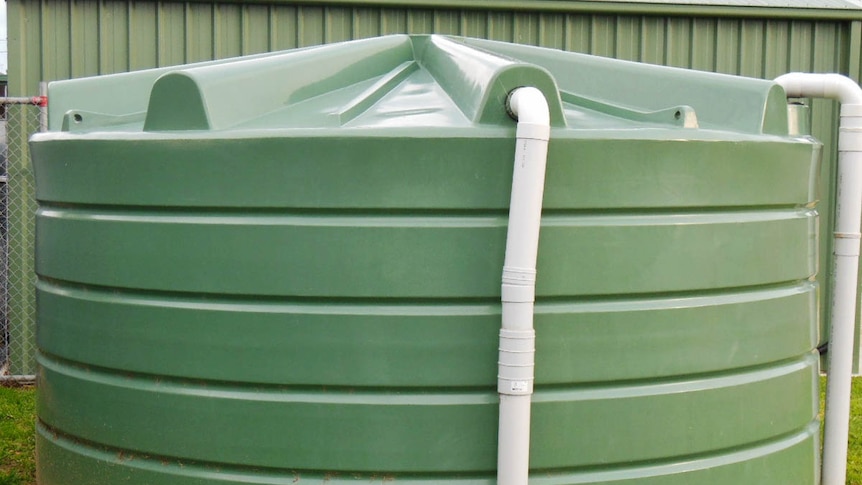 Large green rainwater tank.