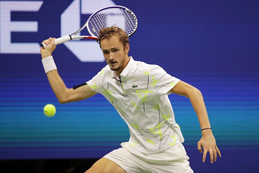 Daniil Medvedev plays a shot with his racquet in his right hand