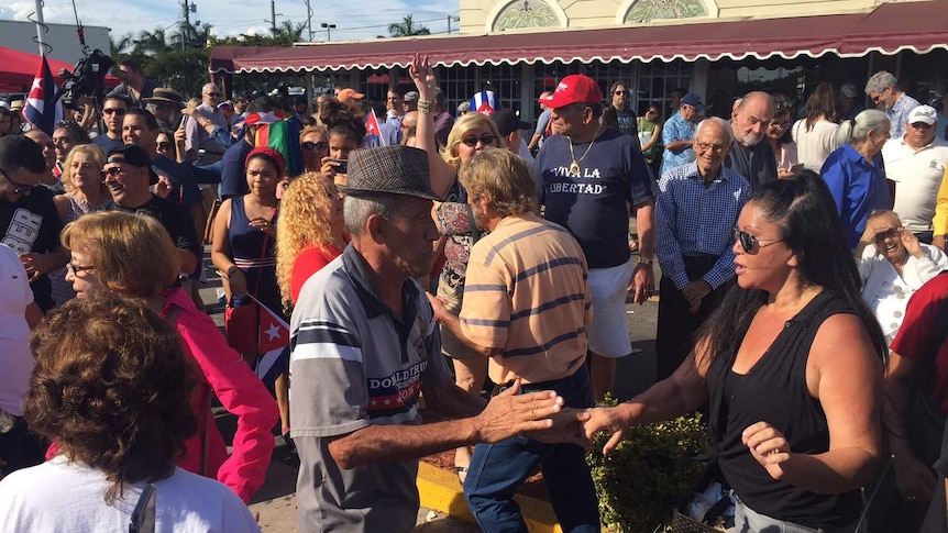 Cuban exiles dance on the street after the death of Fidel Castro in Little Havana, Miami.