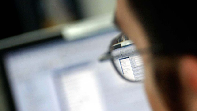 An office worker looks at their computer screen