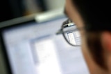 An office worker looks at their computer screen