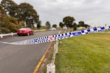 Police tape blocks access to a park.