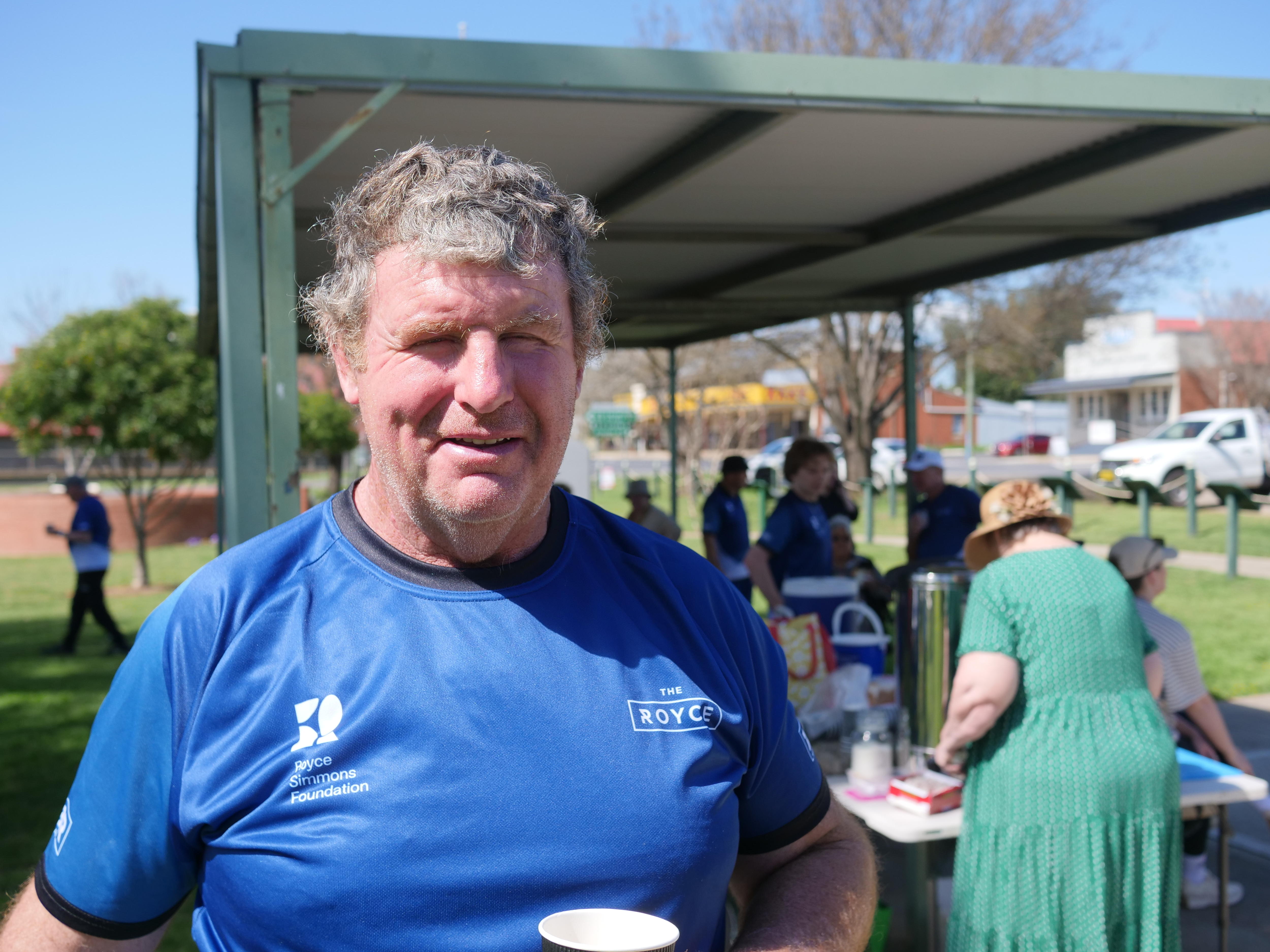 A man standing in front of a BBQ