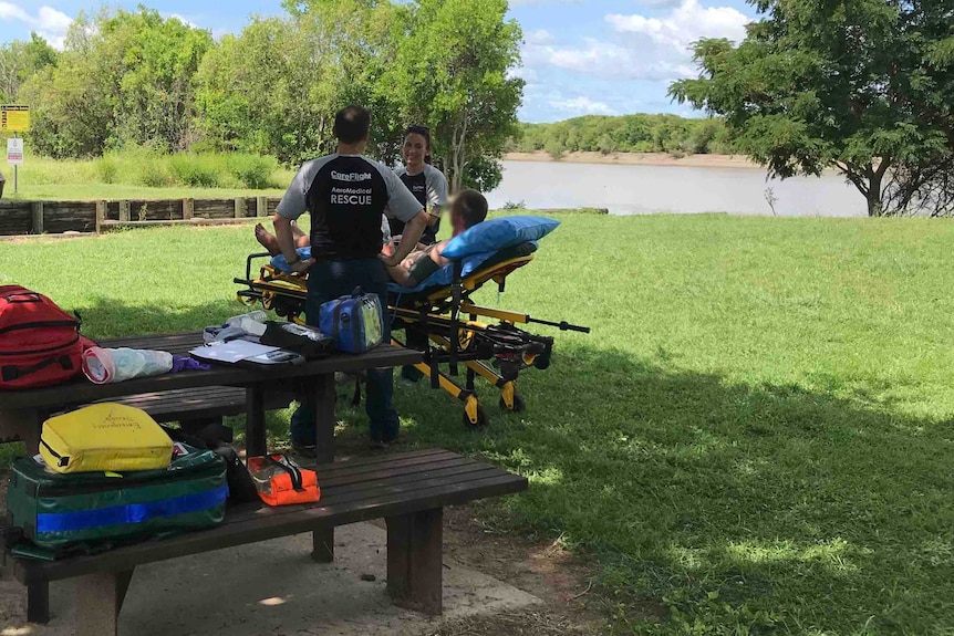 Two rescue nurses assist a fisherman on a stretcher.