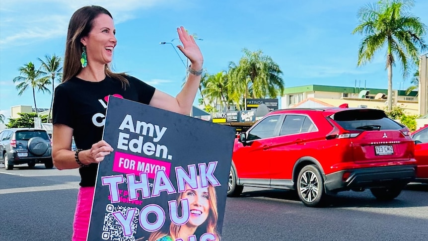 New mayor waves to motorists wearing 'I love Cairns' t-shirt 
