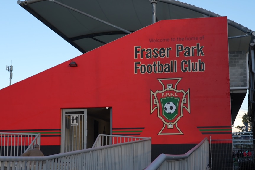 The side of a football grandstand with the words 'Fraser Park Football Club' and a logo.