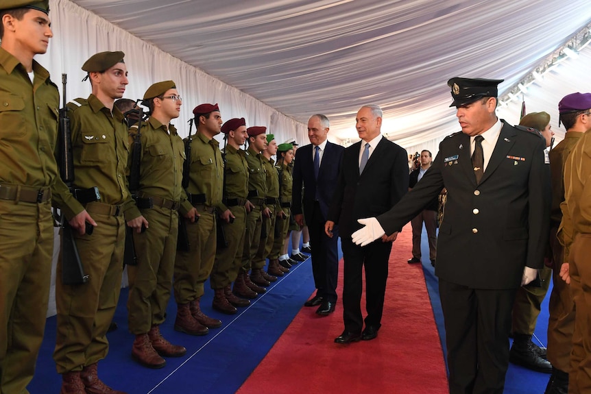 Prime Minister Malcolm Turnbull and Israeli Prime Minister Benjamin Netanyahu walk past a defence force guard of honour.