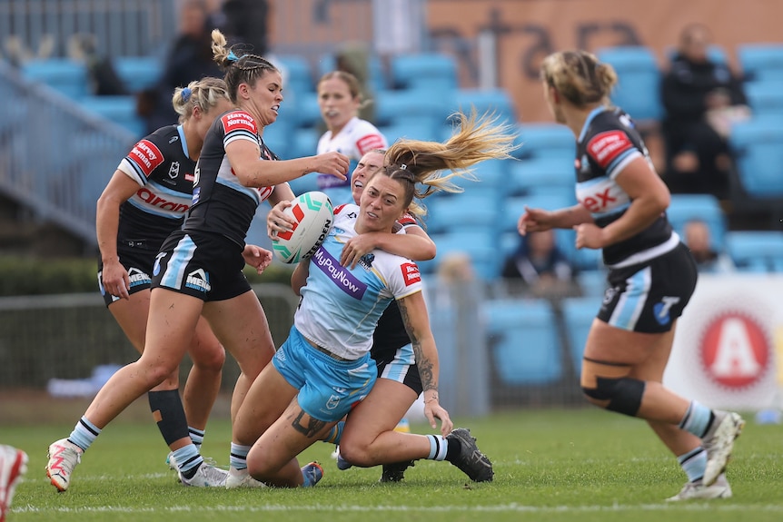 Gold Coast Titans' Niall Williams Guthrie runs into the Cronulla Sharks defence in their NRLW match.