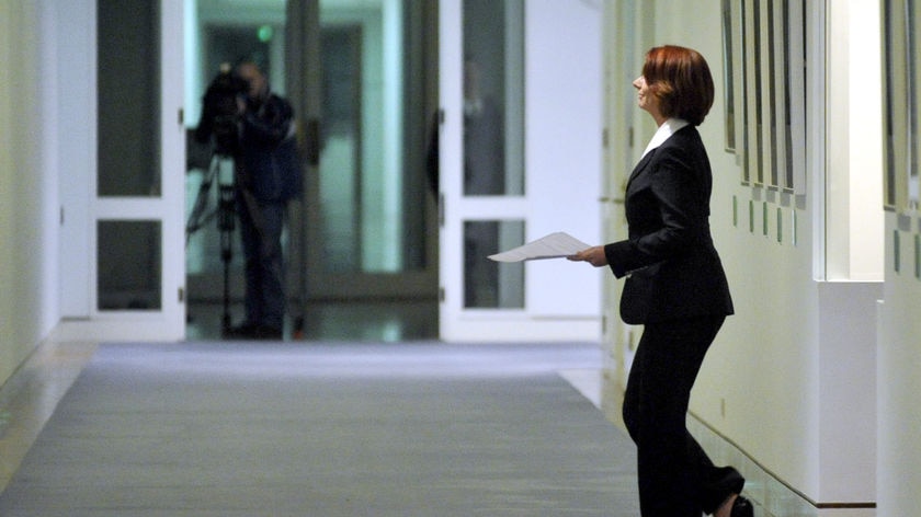 Prime Minister Julia Gillard leaves her office for a meeting with miners in the cabinet room at Parl