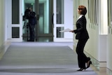 Prime Minister Julia Gillard leaves her office for a meeting with miners in the cabinet room at Parl