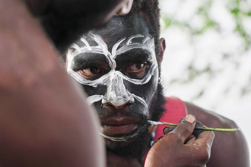 Face paint being applied.