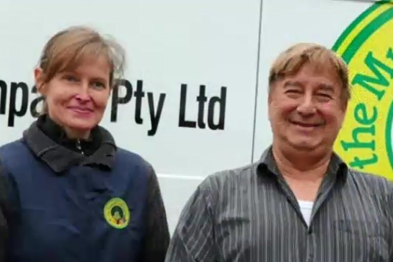 Jennifer Borchardt and Peter Pavlis stand in front of a vehicle carrying the logo of The Muesli Company.
