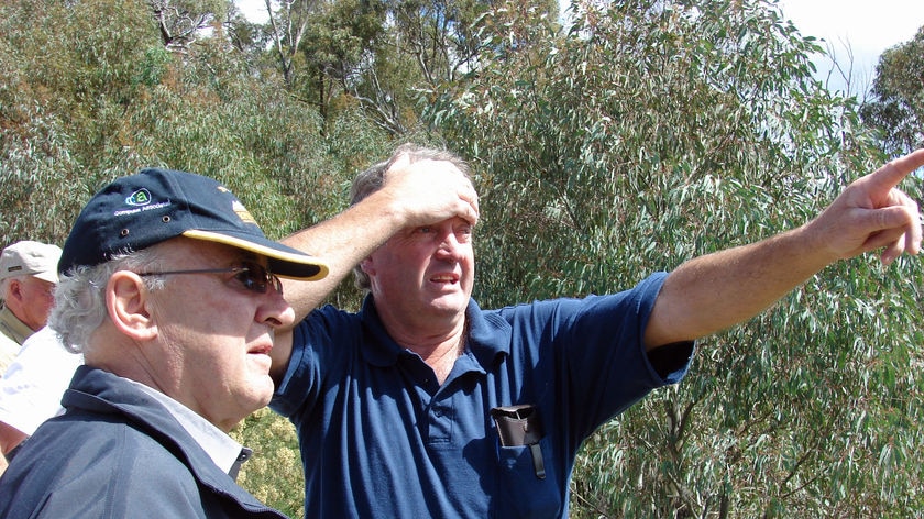 Painful memories: Wayne West shows Chief Justice Terence Higgins the damage caused by the bushfires in 2003.