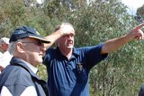 Painful memories: Wayne West shows Chief Justice Terence Higgins the damage caused by the bushfires in 2003.