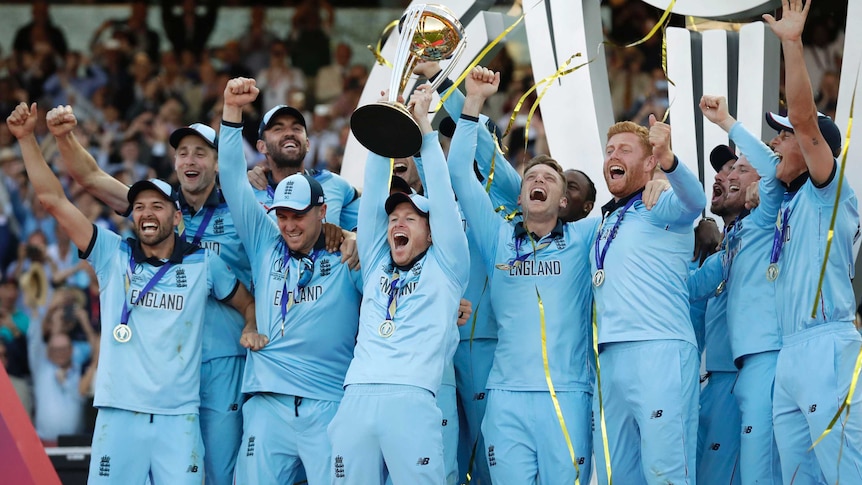 England players celebrate as confetti rains down and Eoin Morgan raises the Cricket World Cup trophy