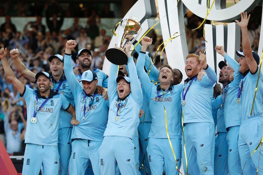 England players celebrate as confetti rains down and Eoin Morgan raises the Cricket World Cup trophy