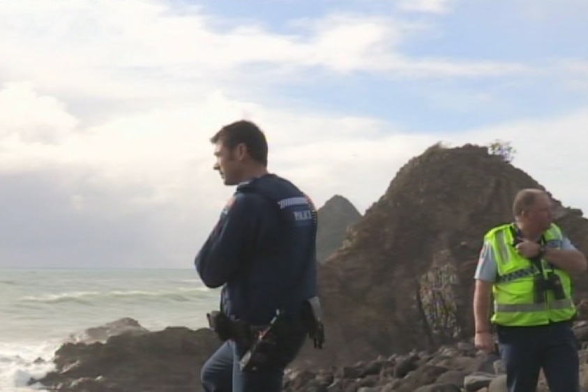 A policeman looks over the cliffs of New Plymouth in NZ