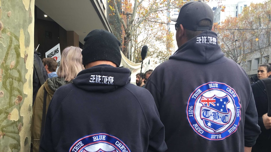 Two men wear jumpers with a True Blue Crew logo in Melbourne.