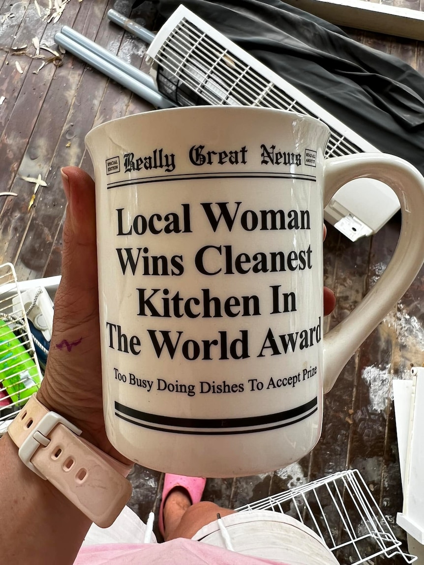A mug that reads 'local woman wins award for cleanest kitchen'