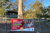 Sign on fence for YMCA Chatswood Hills OSHC at Chatswood State Primary School at Springwood, south of Brisbane.