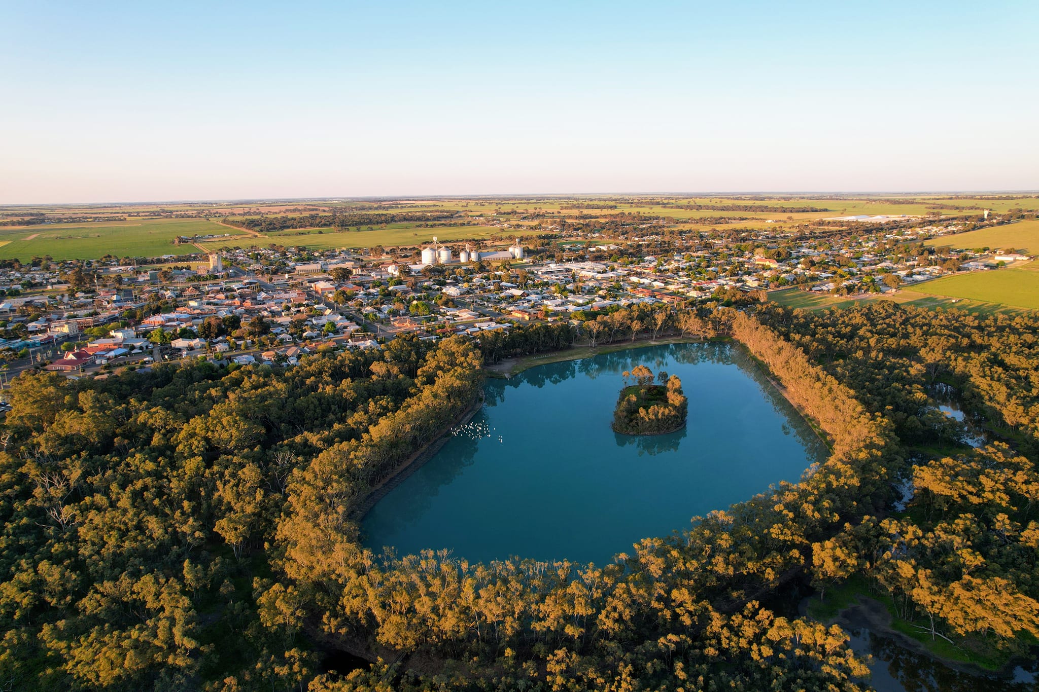 a blue lake surrounded by trees adjoining the town of Nhill in Victoria, Australia