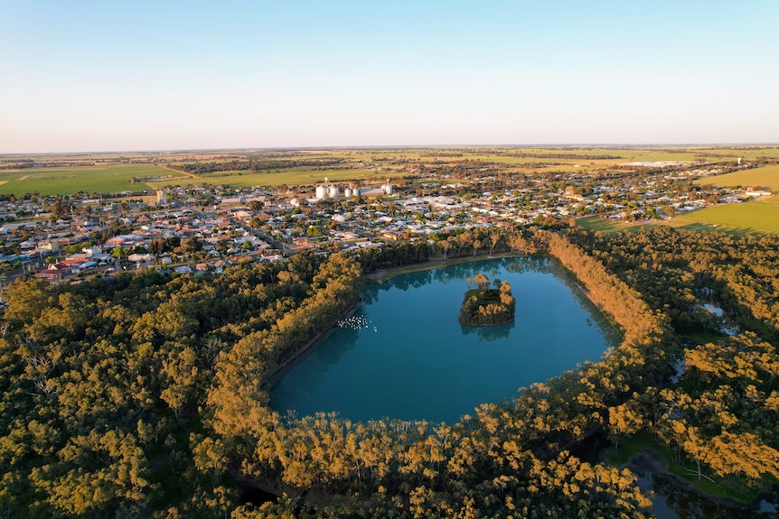 a blue lake surrounded by trees adjoining the town of Nhill in Victoria, Australia