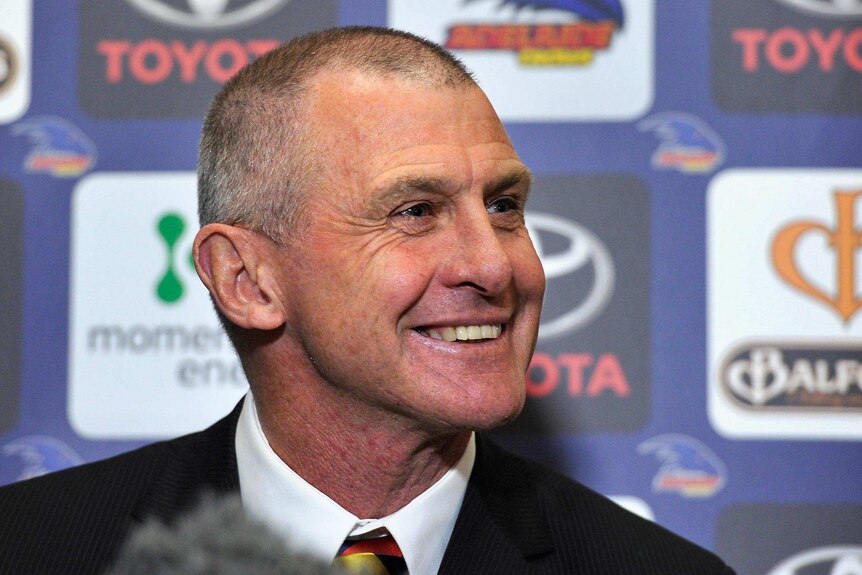 Phil Walsh smiles while speaking to the media