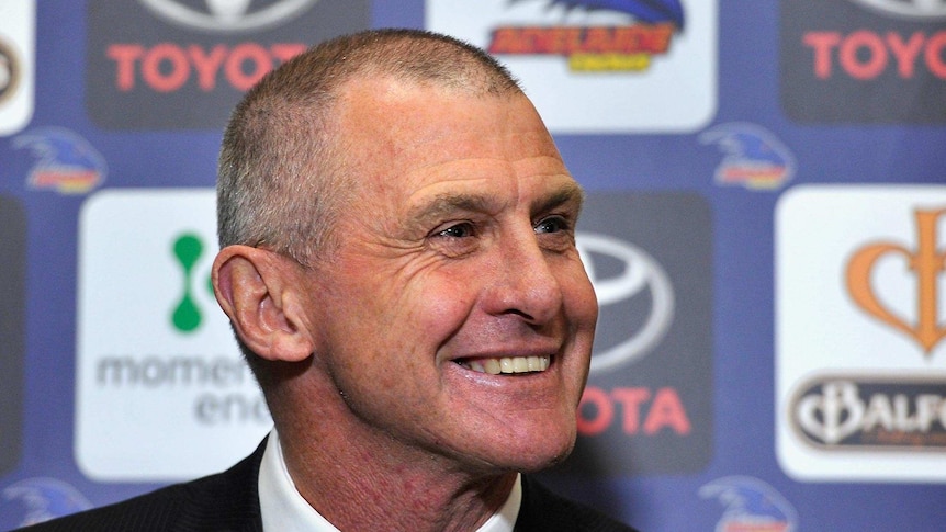 Phil Walsh smiles while speaking to the media