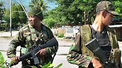 East Timorese soldiers patrol on the outskirts of Dili.