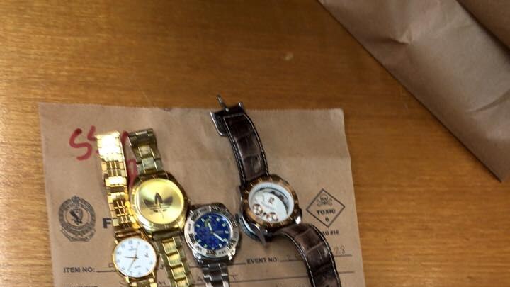 A set of 5 watches on a table