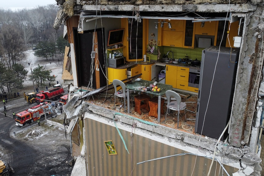 一张被俄罗斯导弹袭击严重损坏的公寓楼内的黄色厨房的视图