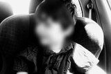 Blurred B&W photo of five-year-old boy in child seat, date unknown.