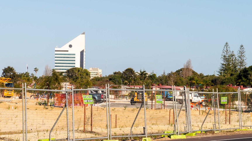 A construction site with the iconic Bunbury Tower in the background