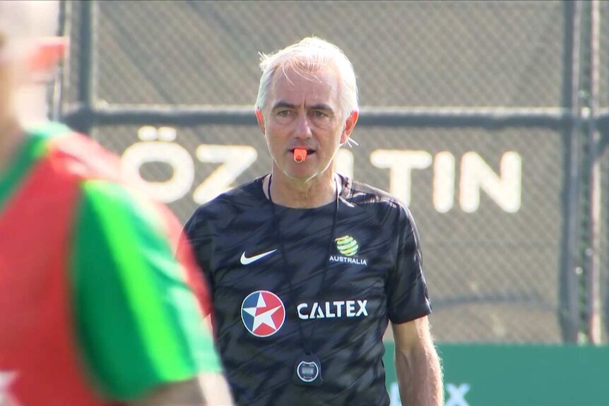 Bert Van Marwijk stares intensely while holding a whistle during a Socceroos training session.