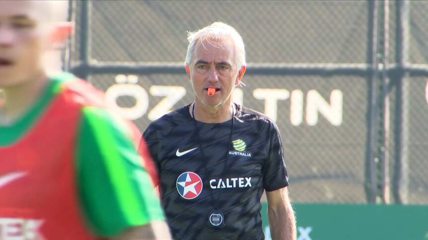 Bert Van Marwijk stares intensely while holding a whistle during a Socceroos training session.
