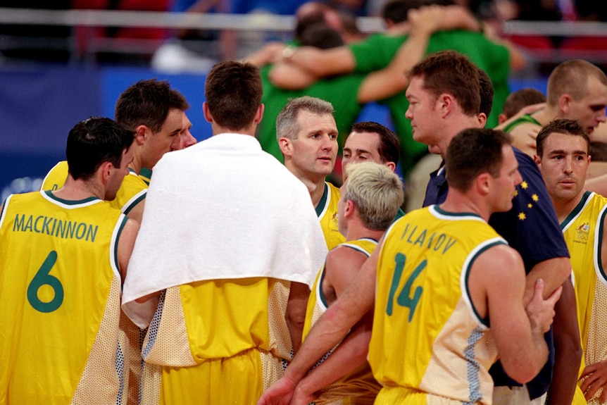 Andrew Gaze stands in a Boomers huddle after the bronze medal game at the Sydney Olympics in 2000.