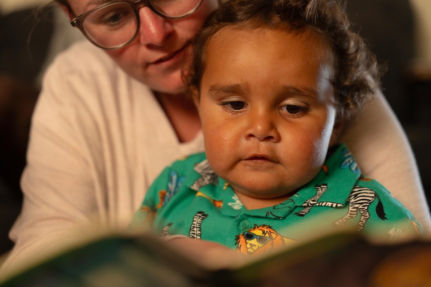 A baby with a book.