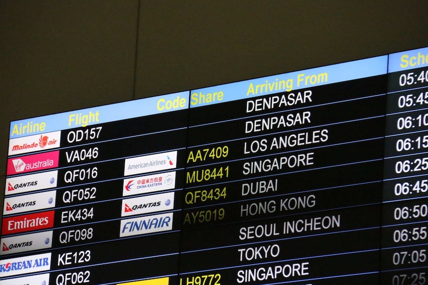 Brisbane Airport arrivals board showing Schapelle Corby's flight from Bali