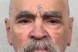 Charles Manson looks down the barrel of the camera for a mugshot photograph.